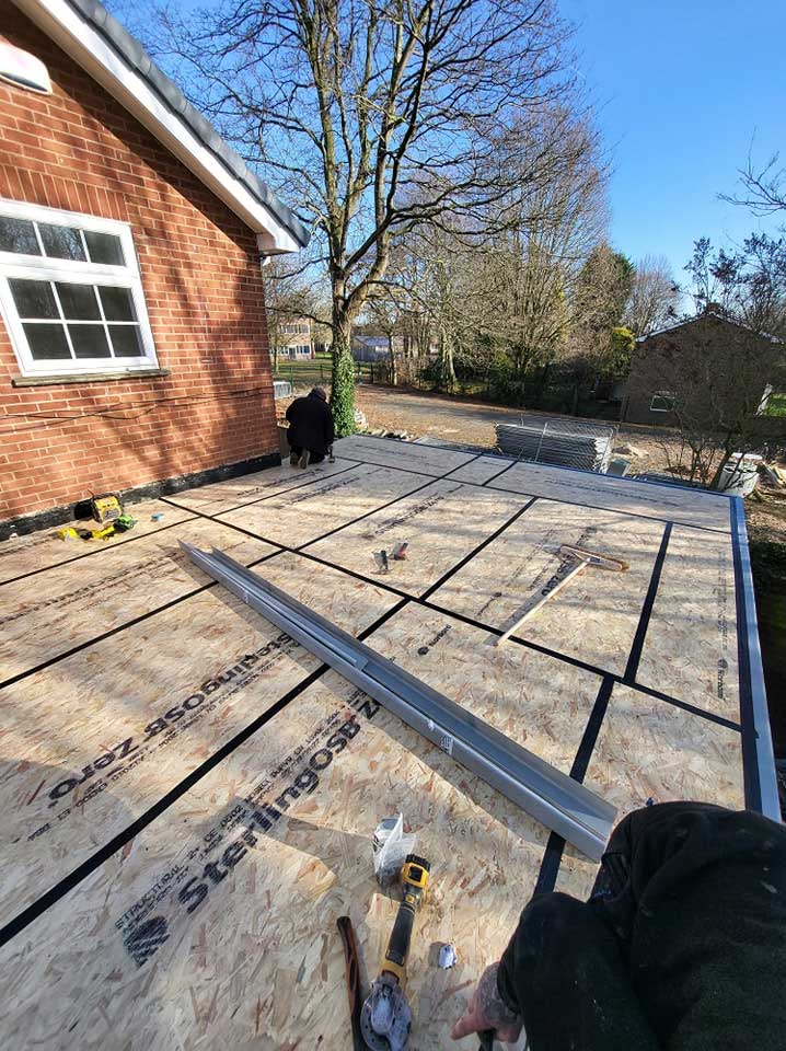 Leicester Roof Repairs Ltd working on flat roof installation.